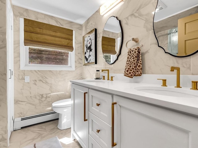 188 Atlantic St, Gloucester, MA 01930 - bathroom featuring a baseboard heating unit, double vanity, marble finish floors, and tile walls