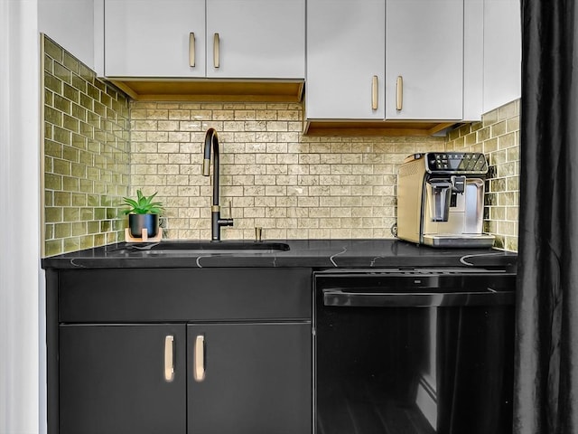 188 Atlantic St, Gloucester, MA 01930 - kitchen with dishwashing machine, dark countertops, white cabinets, and decorative backsplash