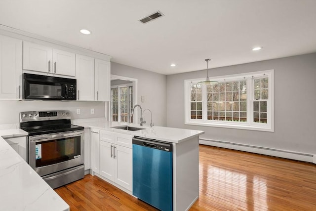 kitchen featuring black microwave, dishwashing machine, a baseboard radiator, a sink, and stainless steel electric range oven