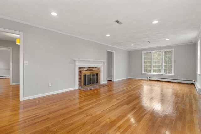 unfurnished living room with visible vents, a baseboard radiator, light wood-style flooring, and crown molding