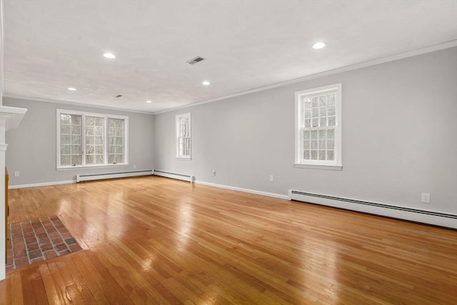 unfurnished living room featuring visible vents, crown molding, baseboards, light wood-style floors, and a baseboard heating unit