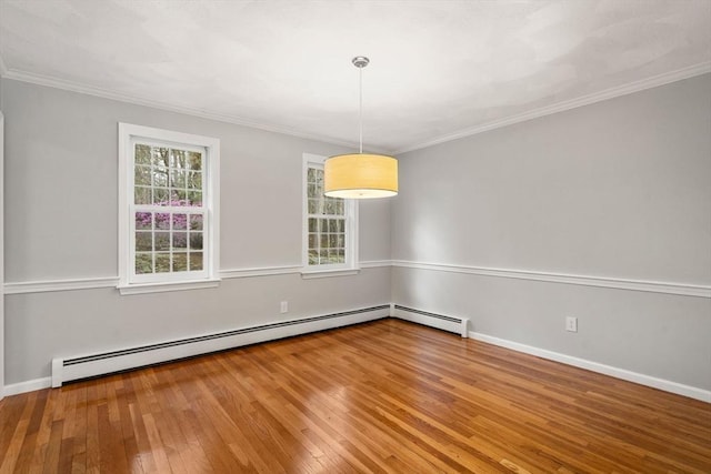 unfurnished room featuring wood-type flooring, ornamental molding, and a wealth of natural light