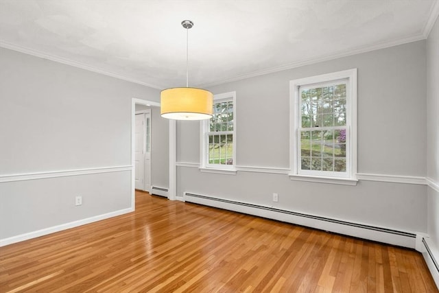 unfurnished dining area featuring light wood-type flooring, ornamental molding, and a baseboard heating unit