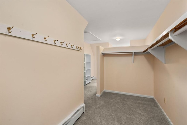 spacious closet featuring carpet floors and baseboard heating