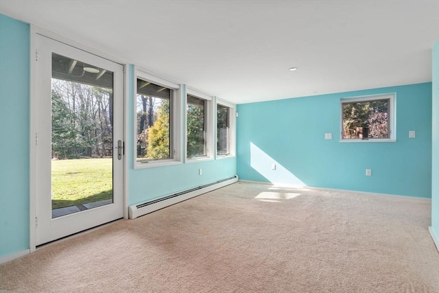 unfurnished room featuring a baseboard heating unit and carpet