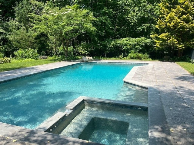 view of swimming pool featuring a patio and a pool with connected hot tub