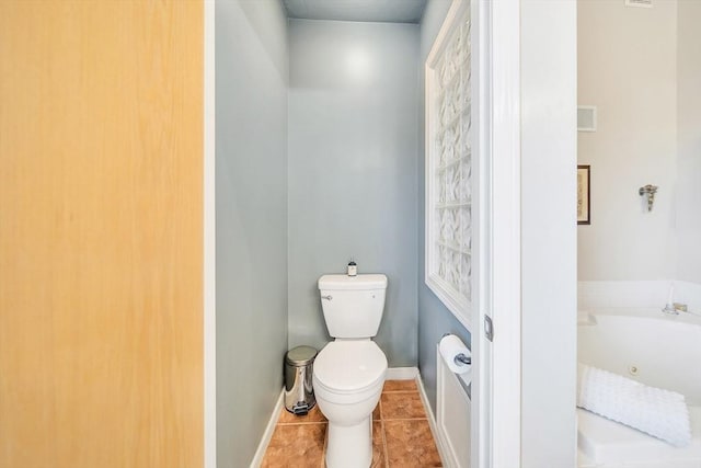 222 Algonquin Unit 222, Ashland, MA 01721 - bathroom with toilet, a jetted tub, baseboards, and tile patterned floors