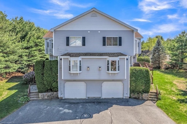 222 Algonquin Unit 222, Ashland, MA 01721 - view of front facade featuring driveway, a garage, a front lawn, and stairs