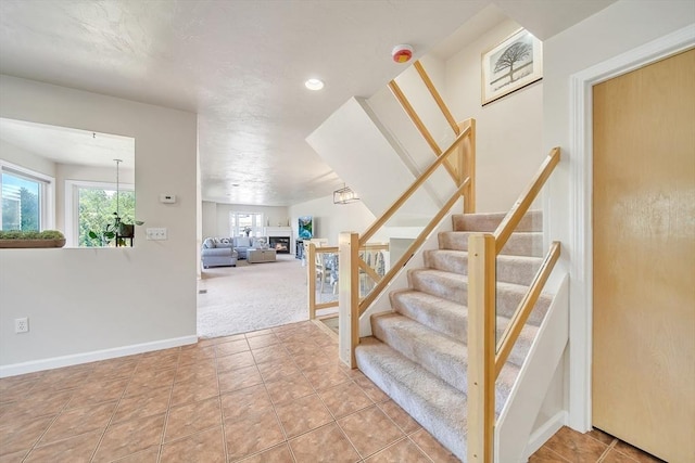 222 Algonquin Unit 222, Ashland, MA 01721 - staircase with recessed lighting, carpet flooring, baseboards, and tile patterned floors