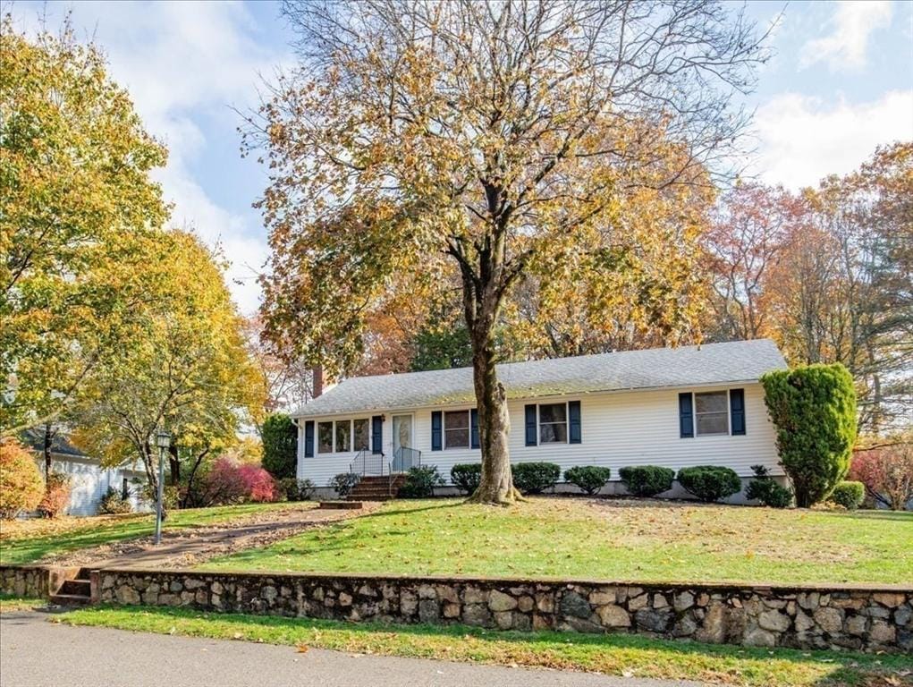 ranch-style home featuring a front yard