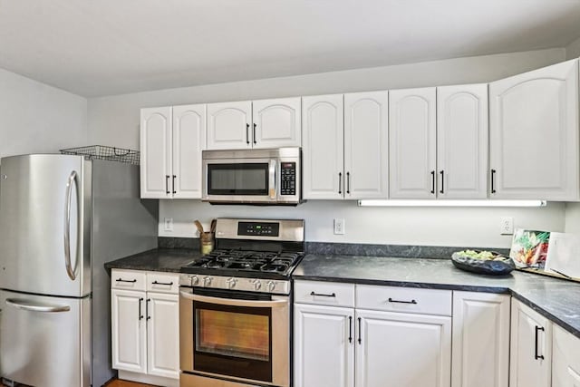 20 Lake St Unit 2, Somerville, MA 02143 - kitchen with appliances with stainless steel finishes, white cabinetry, and dark countertops