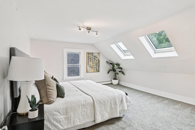 20 Lake St Unit 2, Somerville, MA 02143 - bedroom with a skylight, carpet floors, vaulted ceiling, baseboards, and a baseboard radiator