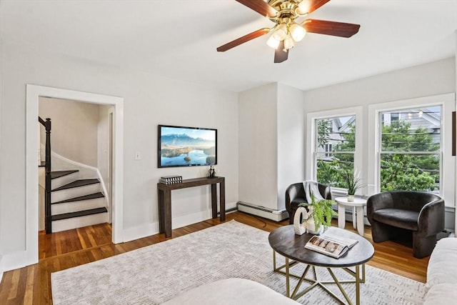 20 Lake St Unit 2, Somerville, MA 02143 - living room with stairs, a baseboard radiator, ceiling fan, and wood finished floors