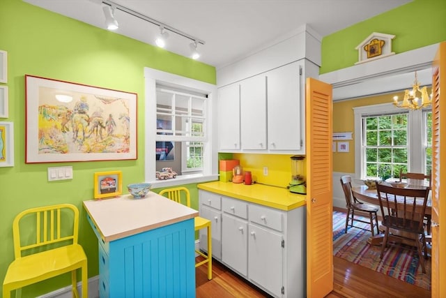 21 Marsh St, Dedham, MA 02026 - kitchen featuring track lighting, white cabinets, a chandelier, and light countertops