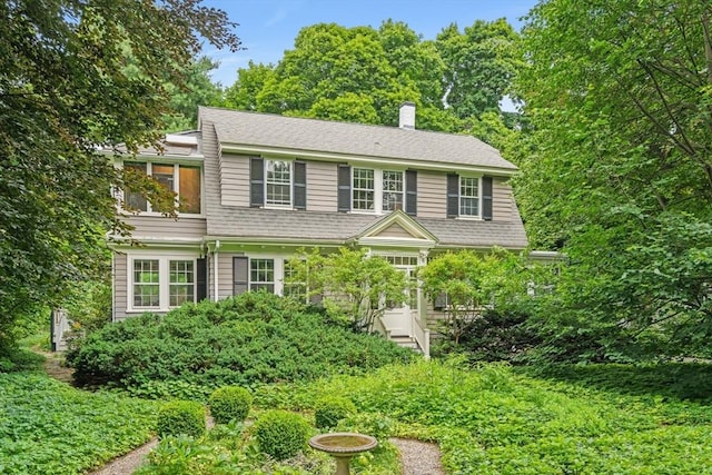 21 Marsh St, Dedham, MA 02026 - view of front facade with a chimney and a wooden deck