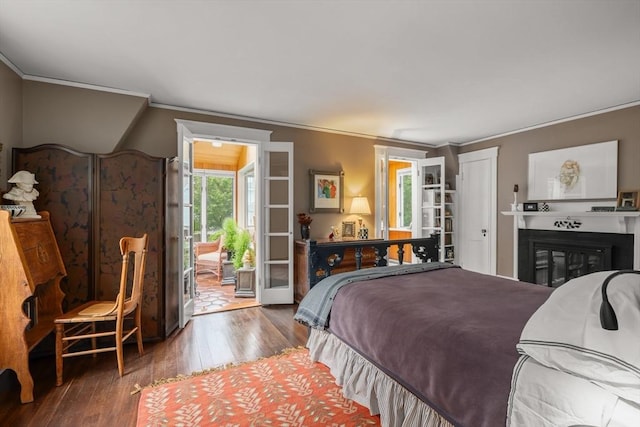 21 Marsh St, Dedham, MA 02026 - bedroom with ornamental molding, wood finished floors, access to exterior, and a glass covered fireplace