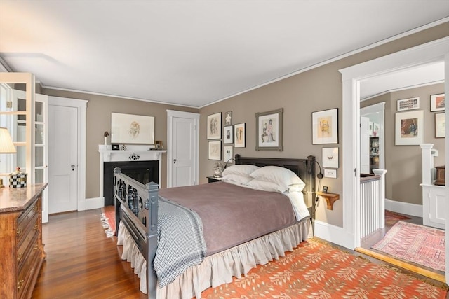 21 Marsh St, Dedham, MA 02026 - bedroom featuring a fireplace, wood finished floors, and ornamental molding