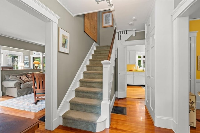 21 Marsh St, Dedham, MA 02026 - staircase with wood finished floors and crown molding