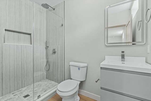 443 Central Ave, Needham, MA 02494 - full bathroom featuring a shower stall, toilet, baseboards, wood finished floors, and vanity