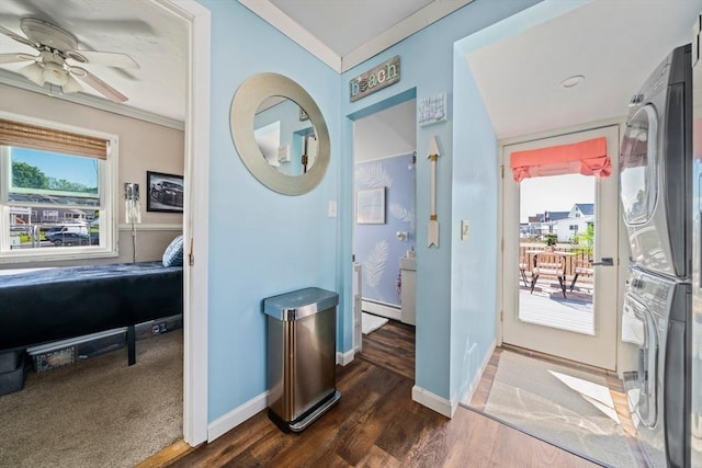 12 Moreland Ave Unit 1, Hull, MA 02045 - foyer featuring stacked washer / drying machine, ornamental molding, ceiling fan, dark wood-style flooring, and baseboards