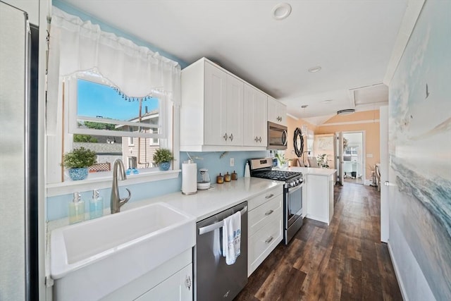 12 Moreland Ave Unit 1, Hull, MA 02045 - kitchen featuring appliances with stainless steel finishes, white cabinets, a sink, dark wood-style flooring, and light countertops