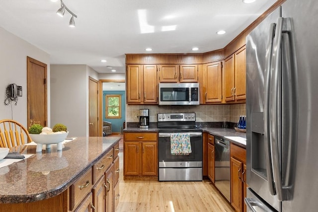 65 Martin Rd, Tewksbury, MA 01876 - kitchen with appliances with stainless steel finishes, brown cabinetry, and light wood finished floors