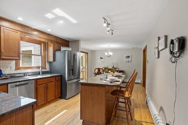 65 Martin Rd, Tewksbury, MA 01876 - kitchen with appliances with stainless steel finishes, light wood finished floors, dark countertops, a center island, and recessed lighting
