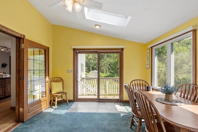 65 Martin Rd, Tewksbury, MA 01876 - dining area featuring vaulted ceiling, ceiling fan, a skylight, and light colored carpet