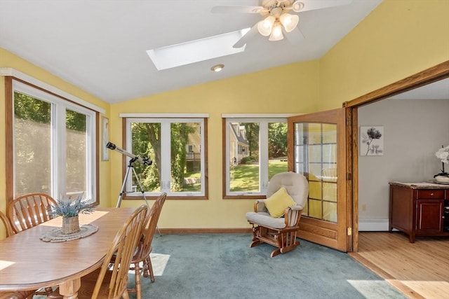 65 Martin Rd, Tewksbury, MA 01876 - dining room with vaulted ceiling, a skylight, a ceiling fan, and light carpet