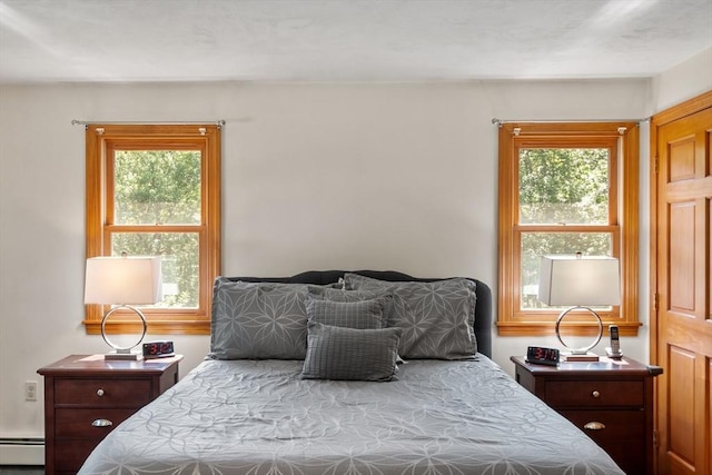 65 Martin Rd, Tewksbury, MA 01876 - bedroom with a baseboard heating unit and multiple windows