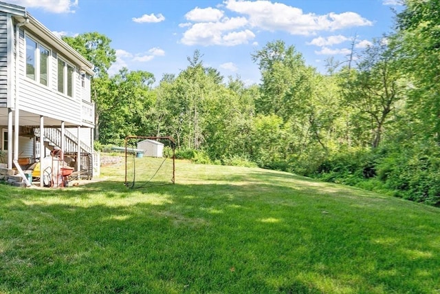 65 Martin Rd, Tewksbury, MA 01876 - view of grassy yard with a shed, stairs, and a view of trees