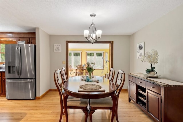 65 Martin Rd, Tewksbury, MA 01876 - dining room with light wood finished floors, healthy amount of natural light, and a chandelier