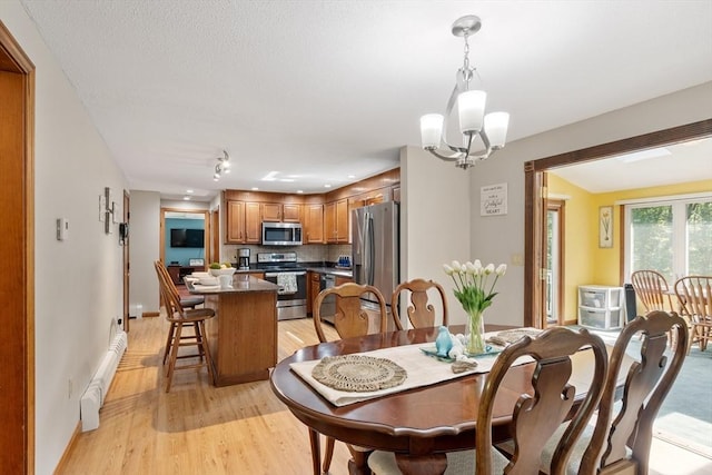 65 Martin Rd, Tewksbury, MA 01876 - dining room with light wood-style floors and a chandelier