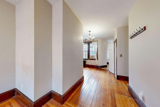70 Revere St Unit 5, Boston, MA 02114 - corridor with hardwood / wood-style flooring, a chandelier, and baseboards