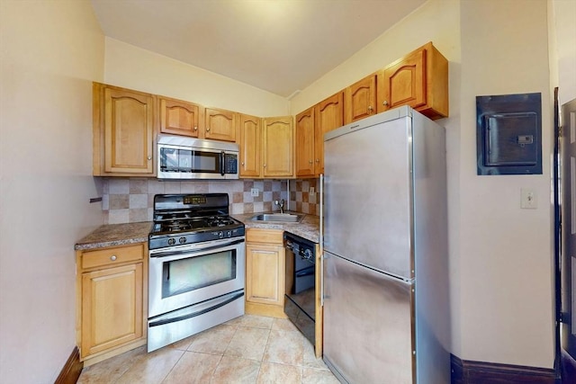 70 Revere St Unit 5, Boston, MA 02114 - kitchen with stainless steel appliances, decorative backsplash, a sink, vaulted ceiling, and light tile patterned floors