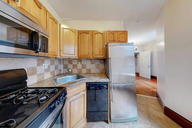 70 Revere St Unit 5, Boston, MA 02114 - kitchen featuring appliances with stainless steel finishes, a sink, backsplash, baseboards, and light countertops