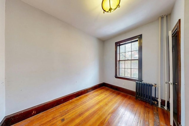 70 Revere St Unit 5, Boston, MA 02114 - spare room featuring hardwood / wood-style floors, baseboards, and radiator heating unit