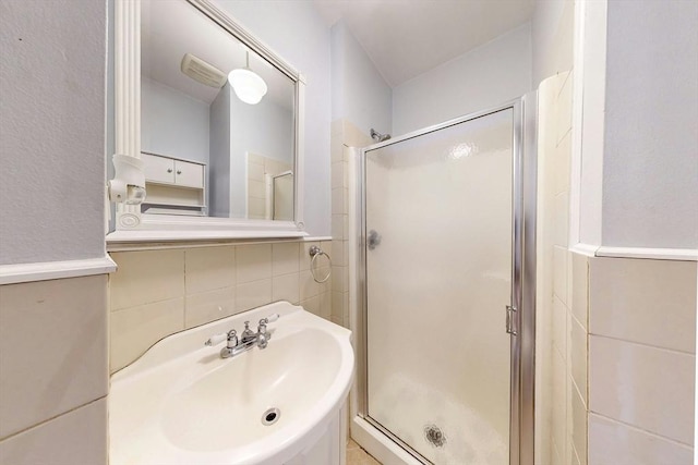 70 Revere St Unit 5, Boston, MA 02114 - bathroom with a stall shower, a sink, tile walls, and tasteful backsplash