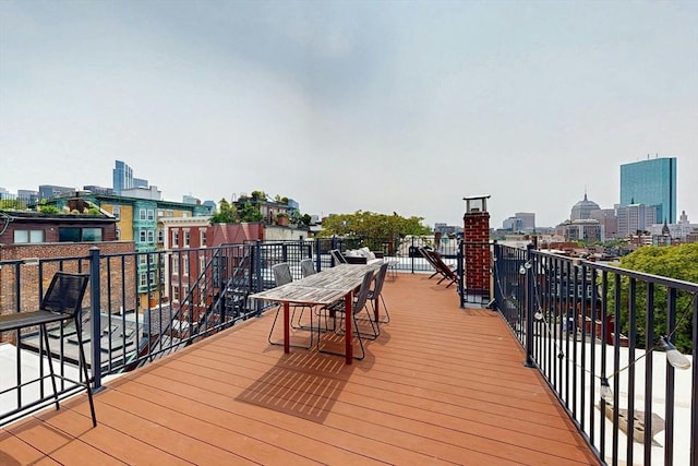 70 Revere St Unit 5, Boston, MA 02114 - wooden deck with a view of city and outdoor dining area