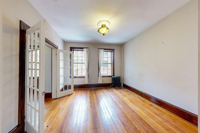 70 Revere St Unit 5, Boston, MA 02114 - unfurnished room with radiator heating unit, hardwood / wood-style flooring, french doors, and baseboards