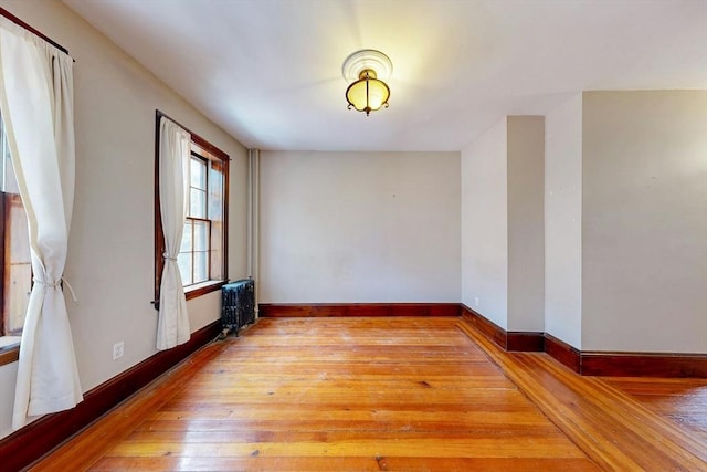 70 Revere St Unit 5, Boston, MA 02114 - spare room with radiator heating unit, light wood-style floors, and baseboards