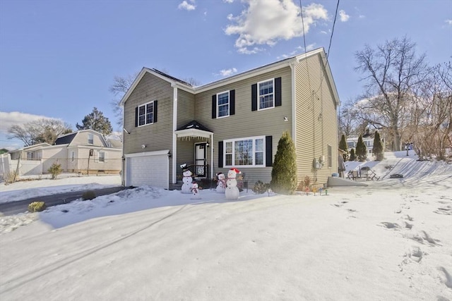 view of front of home with a garage and fence