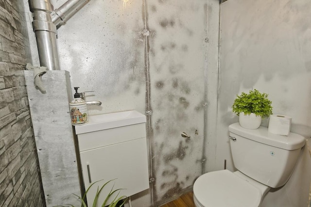 bathroom featuring toilet and vanity