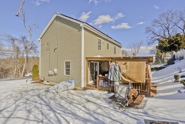 snow covered property with a deck