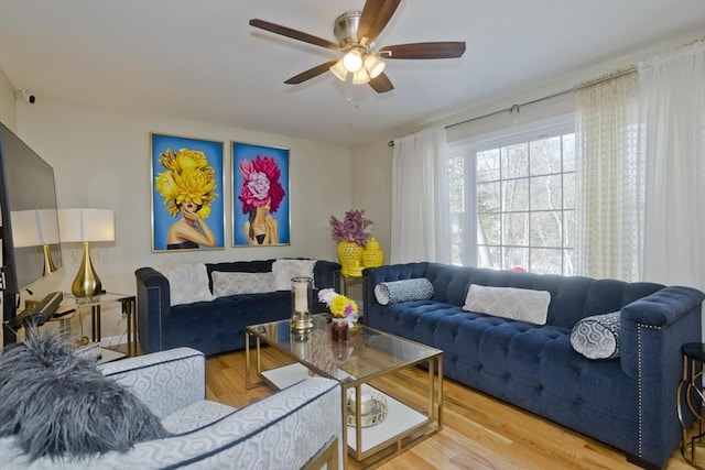 living area featuring wood finished floors and a ceiling fan