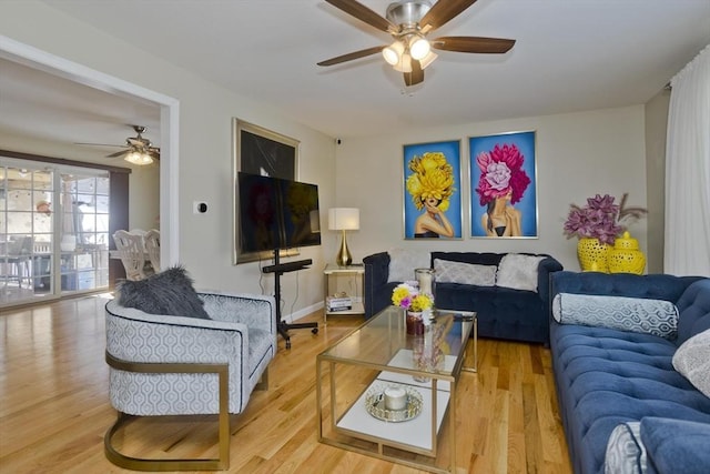 living room featuring ceiling fan, wood finished floors, and baseboards