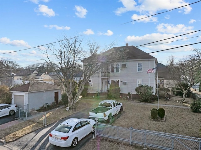 view of front of property with a garage and fence