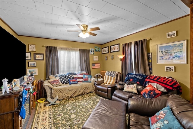 living room featuring ornamental molding and a ceiling fan