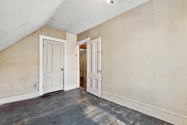 bonus room featuring vaulted ceiling and wood finished floors