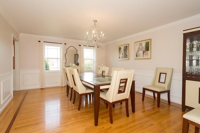 113 Sparrow Rd, Stoughton, MA 02072 - dining space with a chandelier, light wood-style flooring, ornamental molding, a wainscoted wall, and a decorative wall